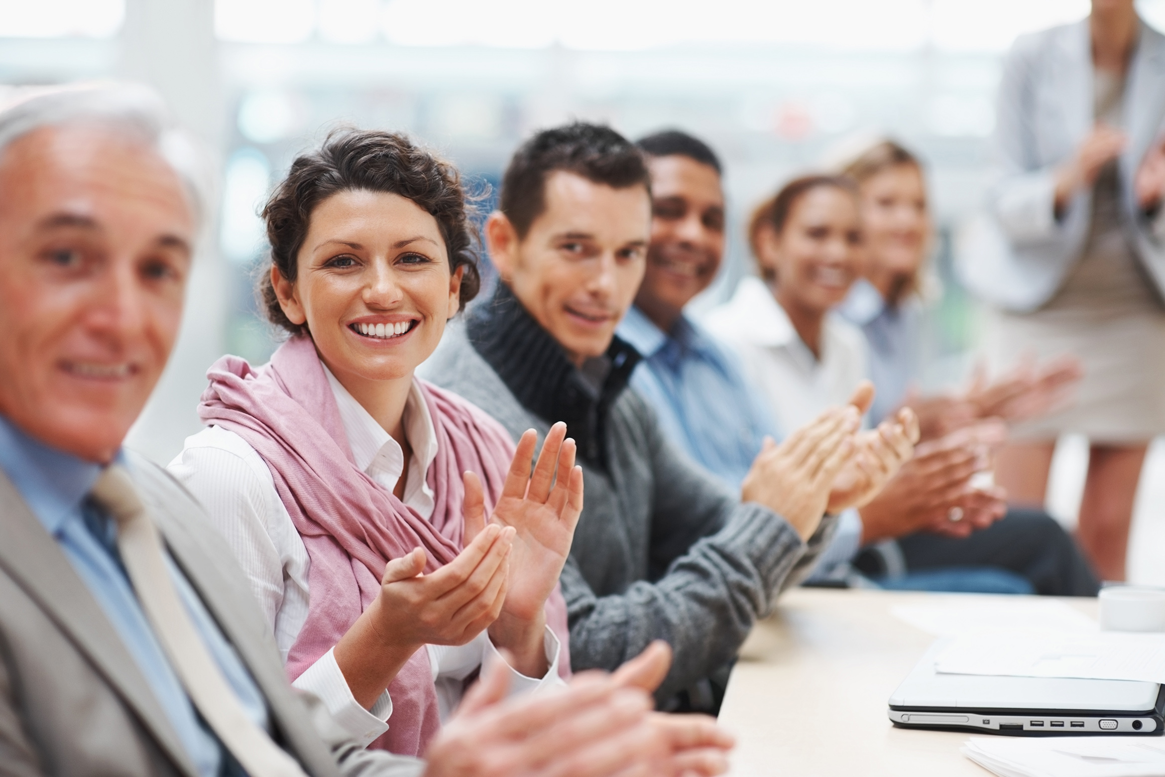 Successful business executive applauding at a conference